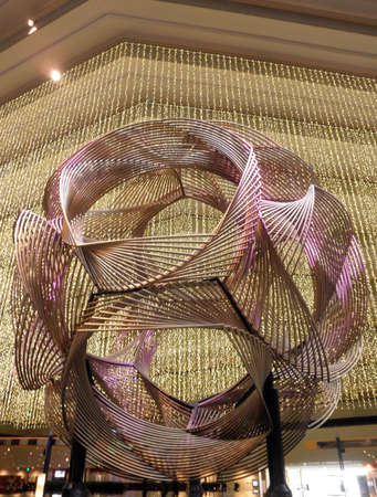 sculpture with x-mas light hanging behind it inside a fancy hotel in san francisco.の写真素材