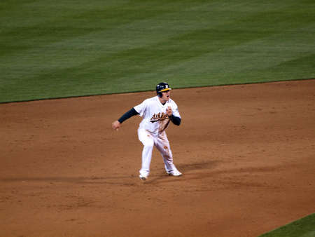 Red Sox vs. Athletics: Athletics Cliff Pennington makes a face as he breaks towards 3rd during a hit.  Taken on July 19, 2010 at the Coliseum in Oakland California.のeditorial素材