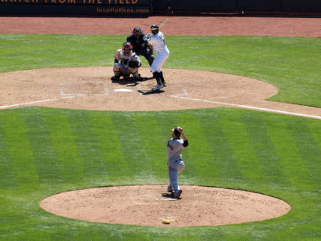 Bay Bridge Series: Giants pitcher throws ball toward homeplate with Athletics batter Raja Davis waiting for pitch with  catcher and umpire standing behind them. May 23, 2010 The Oakland Coliseum featuring Baseball players and fans.のeditorial素材
