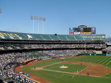 Royals vs. Athletics: Royals Brayan Pena batting looks at a incoming fastball from As Brett Anderson with runner at first.  Whole field view taken on August 4 2010 at Coliseum in Oakland California.のeditorial素材