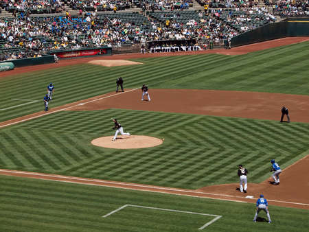 Royals vs. Athletics: As Brett Anderson throws pitch with runners on 1st and 3rd taking large leads.  Taken on August 4 2010 at Coliseum in Oakland California.のeditorial素材