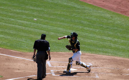 Blue Jays vs. Athletics: Athletics Kurt Suzuki throws from home during between inning drills.  Taken on August 18 2010 at Coliseum in Oakland California.のeditorial素材