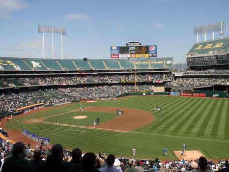 Kanasa City Royals vs Oakland A's:Royals Players and Oakland fans stand with hats removed during the national anthem before the start of the game.  August 3 2010 at the Coliseum in Oakland California のeditorial素材