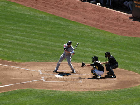 Blue Jays vs. Athletics: Blue Jays Lyle Overbay looks at incoming pitch as it crosses plate with Athletics Kurt Suzuki catching.  Taken on August 18 2010 at Coliseum in Oakland California.のeditorial素材