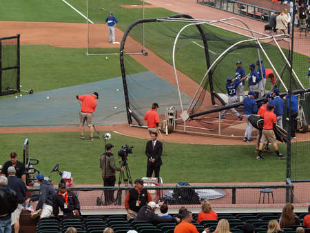Dodger vs. Giants: Comcast sportcaster smiles for camera as Dodgers take batting practice.    July 30, 2010 Att Park in San Francisco CA.のeditorial素材