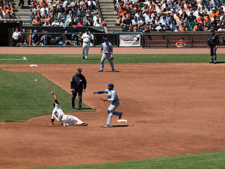 Giants Vs. Cubs: Cubs Starlin Castro throws to 1st as he turns a double play as Giants Freddy Sánchez slides feet first into 2nd base.  August 12  2010 Att Park San Francisco Californiaのeditorial素材