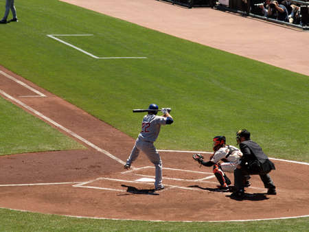 Giants Vs. Marlins: Cubs Xavier Nady lifts leg high in to get ready to try to hit pitch with catcher Buster Posey squating behind him.  August 12  2010 Att Park San Francisco Californiaのeditorial素材