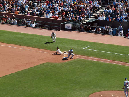 Giants Vs. Cubs:Giants Giants Aaron Rowand slides hands first though first to beat close throw that first baseman Xavier Nady catches in chest.  August 12  2010 Att Park San Francisco Californiaのeditorial素材