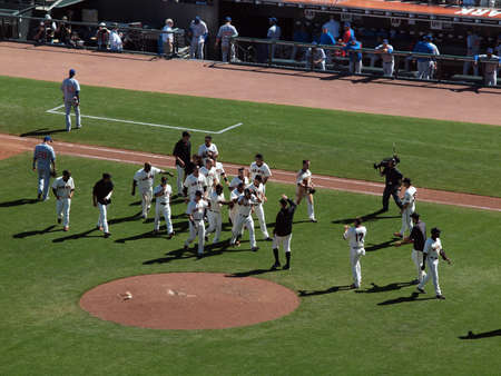 Giants Vs. Cubs:Giants Andres Torres gets mobbed by teammates in celebration as players go to give him high fives after hitting game winning single.  August 12  2010 Att Park San Francisco Californiaのeditorial素材