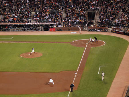 Giants Vs. Padres: Giants pitcher Barry Zito throwing a pitch to Padres batter Chase Headley with thirdbaseman squating during a night game.  Taken May 11 2010 at Att Park San Francisco Californiaのeditorial素材