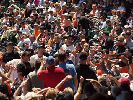 Giants Vs. Cubs: Giants fans reach out for an incoming foul fly ball in the stands.  August 12  2010 Att Park San Francisco Californiaのeditorial素材