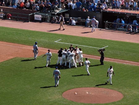 Giants Vs. Cubs: Giants Andres Torres gets mobbed by teammates in celebration after hitting game winning single.  August 12  2010 Att Park San Francisco Californiaのeditorial素材