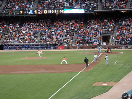 Dodger vs. Giants: Giants Tim Lincecum throws pitch by a Dodger as Catcher Buster Posey catches ball with Dodger runner Blake DeWitt taking lead at 3rd.  Taken from the 3rdbase line on July 30, 2010 Att Park in San Franciscoのeditorial素材