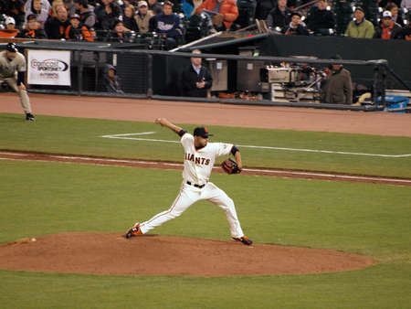 Giants Vs. Padres: Giants pitcher Sergio Romo steps forward to throw a pitch in relief during a night game.  Taken May 11 2010 at Att Park San Francisco Californiaのeditorial素材