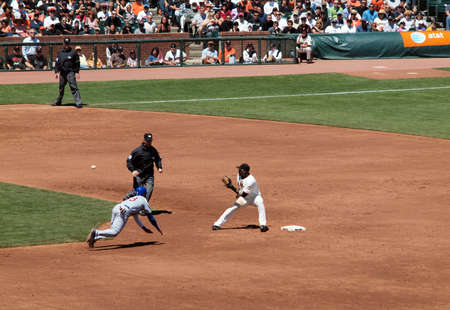 Giants Vs. Cubs: Giants Juan Uribe stands on 2nd as he waits for ball thrown from catcher as Cubs Starlin Castro slides into 2nd trying to steal.  August 12  2010 Att Park San Francisco Californiaのeditorial素材