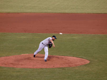 New York Mets vs. San Francisco Giants:  Mets Francisco Rodriguez in motion after throwing pitch off the mound.  Ball can be seen flying in the air.  Taken July 17 2010 at the ATT Park San Francisco.のeditorial素材