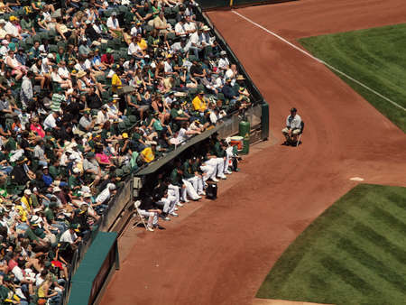 Royals vs. Athletics: Oakland Athletics pitchers sit the the bullpen with fans sittint behind them.  Taken on August 4 2010 at Coliseum in Oakland California.のeditorial素材