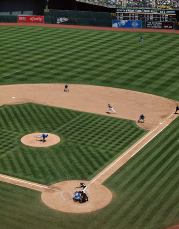 Royals vs. Athletics: Chad Pennington breaks for second as Coco Crisp tries to lay down a bunt with ball in air.  Taken on August 4 2010 at Coliseum in Oakland California.のeditorial素材