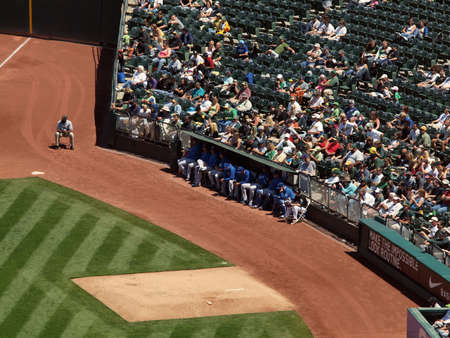 Royals vs. Athletics: Kansas City Royals pitchers sit the the bullpen with fans sitting behind them. .  Taken on August 4 2010 at Coliseum in Oakland California.のeditorial素材
