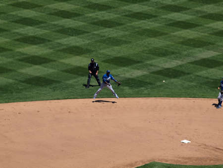 Royals vs. Athletics: Royals Shortstop Yuniesky Betancourt throws to first base while in the midair.  Taken on August 4 2010 at Coliseum in Oakland California.のeditorial素材