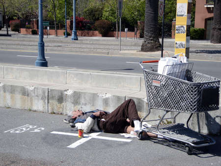 Homeless man sleeps on his shoes along the Embarcadero in San Francisco California, April 15, 2009のeditorial素材