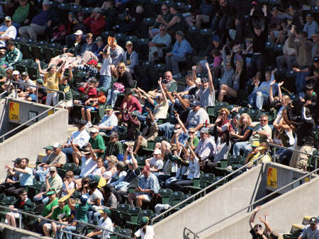 Blue Jays vs. Athletics: Athletics Some Athletics fans do the wave while other chpice to remain sitting.  Taken on August 18 2010 at Coliseum in Oakland California.のeditorial素材