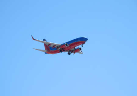 Southwest Airplane flies in the air as it drops wheels to land at the San Jose Airport California.  Taken August 5, 2010のeditorial素材