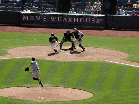 Blue Jays vs. Athletics: Athletics Cliff Pennington bunts ball and begins to run of pitch from Blue Jays Casey Janssen.  Taken on August 18 2010 at Coliseum in Oakland California.のeditorial素材