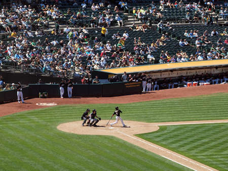 Blue Jays vs. Athletics: Athletics Coco Crisp hits homerun swing though as he watches ball soar away as does Blue Jays catcher.  Taken on August 18 2010 at Coliseum in Oakland California.のeditorial素材