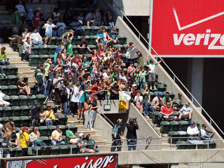 Blue Jays vs. Athletics: Young Athletics fans go crazy for Camera man to get displayed on the teams video scoreboard .  Taken on August 18 2010 at Coliseum in Oakland California.のeditorial素材