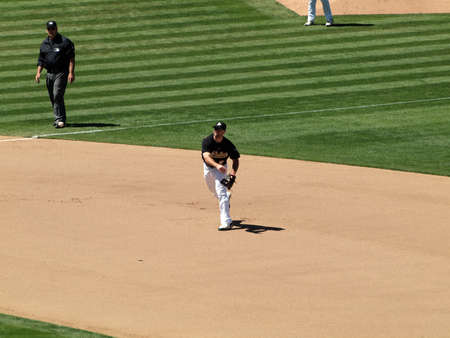 Blue Jays vs. Athletics: Athletics 3rd baseman Kevin Kouzmanoff throws hard to 1st base, ball can be seen in air.  Taken on August 18 2010 at Coliseum in Oakland California.のeditorial素材