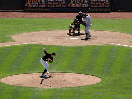 Blue Jays vs. Athletics: Athletics sidearm pitcher Brad Ziegler in throwing motion to pitch to Blue Jays Yunel Escobar with catcher Kurt Suzuki waiting for pitch.  Taken on August 18 2010 at Coliseum in Oakland California.のeditorial素材