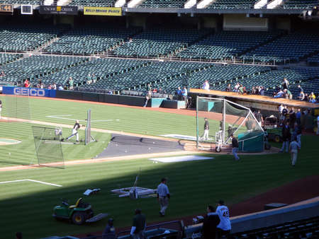 Blue Jays vs. Athletics: Blue Jays take batting practice before game againts the Athletics as a couple of fans watch the action.  Taken on August 16 2010 at Coliseum in Oakland California.のeditorial素材