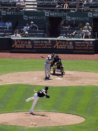Blue Jays vs. Athletics: Athletics Jerry Blevins throws pitch to Blue Jays Fred Lewis who connects with a big swing with catcher Kurt Suzuki waiting for pitch.  Taken on August 18 2010 at Coliseum in Oakland California.のeditorial素材