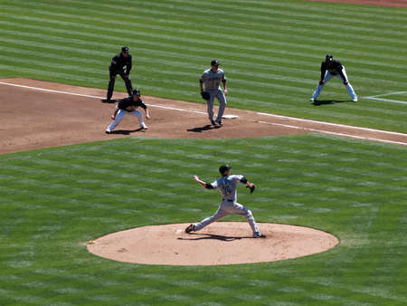 Blue Jays vs. Athletics: Blue Jays Pitcher Marc Rzepczynski in motion to throw with As Cliff Pennington taking lead at 1st.  Taken on August 18 2010 at Coliseum in Oakland California.のeditorial素材