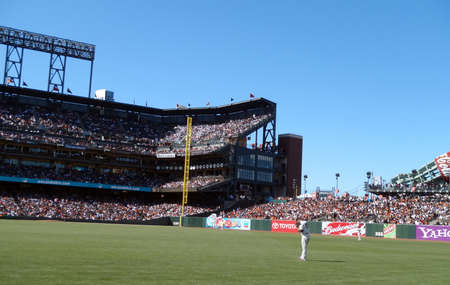 San Diego Padres Vs. San Francisco Giants: Giants Aubrey Huff looks at his shoe in right field between plays with rest of outfield visible.  Taken August 14 2010 at ATT Park in San Francisco California.のeditorial素材