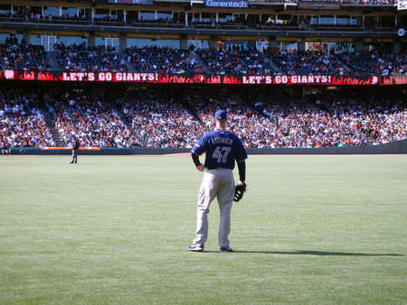 San Diego Padres Vs. Padres Ryan Ludwick stands in right field  between plays with a 'Let's Go Giants Sign on the long digital scoreboard.  Taken August 14 2010 at ATT Park in San Francisco California.のeditorial素材