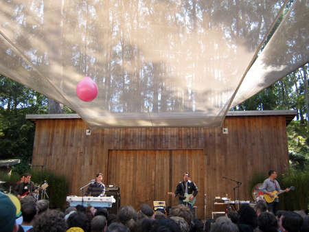 73rd Stern Grove Festival:  They Might Be Giants preforms during the opening act to a large crowd at outdoor concert with pink balloon flying though the crowd.  August 22 2010 San Francisco CA.のeditorial素材