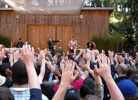 73rd Stern Grove Festival:  Fans raise hands in the air during a song by They Might Be Giants at outdoor concert.  August 22 2010 San Francisco CA.のeditorial素材