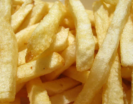Close up of American Fast food style fresh french fries light sprinkling of salt and pepperの写真素材