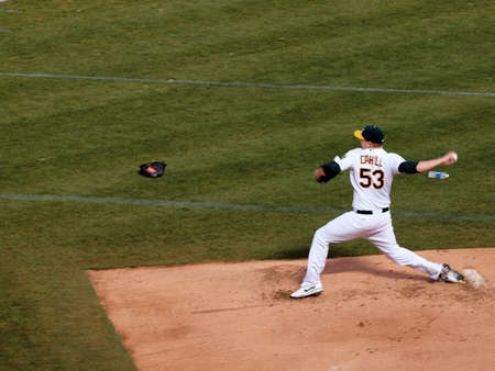 White Sox vs. Athletics: A's Trevor Cahill steps forward to throw a pitch as he warms up in the bullpen. Taken on September 21 2010 at Coliseum in Oakland California.のeditorial素材