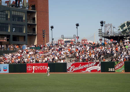 Reds vs. Giants: Giants Outfielders watch homerun ball go over heads as fans stand in excitement.  August 25 2010 at the ATT park San Francisco California.のeditorial素材