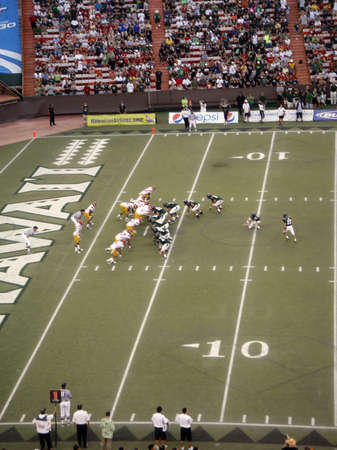 USC vs. UH: UH place holder grabs ball as kicker is about to kick field goal. taken on September 2, 2010 at Aloha Stadium in Honolulu, Hawaii.のeditorial素材