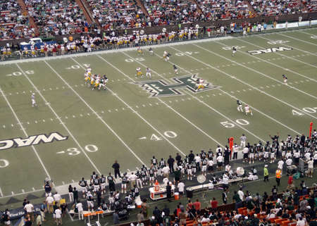 USC vs. UH: USC Quarterback sets to throw as runners break at start of play. taken on September 2, 2010 at Aloha Stadium in Honolulu, Hawaii.のeditorial素材