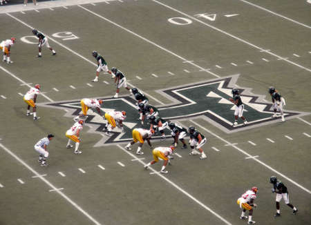 USC vs. UH: UH Quarterback sets for ball before start of play with both teams lined up. taken on September 2, 2010 at Aloha Stadium in Honolulu, Hawaii.のeditorial素材