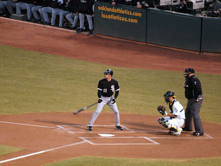 White Sox vs. Athletics: White Sox Omar Vizquel stands in the batters box with As Kurt Suzuki catching during a night game. Taken on September 21 2010 at Coliseum in Oakland California.のeditorial素材