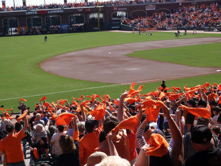 Padres vs. Giants: Fans wave orange towels to pump up team before the start of the game.  taken on October 2 2010 at Att Park in San Francisco California.のeditorial素材