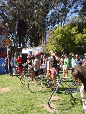SAN FRANCISCO - SEPTEMBER 25:  Man drinks a beer on his bike as he waits in a line with other bikers for the start of the Slow Race at Tour De Fat 2010.   September 25, 2010 Golden Gate Park San Francisco.のeditorial素材