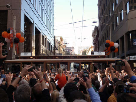 SAN FRANCISCO, CA - NOVEMBER 3: During Giants Parade Cable Car with Sergio Romo and Brian Wilson rolls down the street as people take photos and cheer Nov. 3, 2010 San Francisco, CA.のeditorial素材