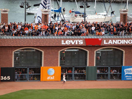 SAN FRANCISCO, CA - OCTOBER 28: Right fielder Cody Ross reach glove into the air to catch ball at warning track game 2 of the 2010 World Series game between Giants and Rangers Oct. 28, 2010 AT&T Park San Francisco, CA. のeditorial素材